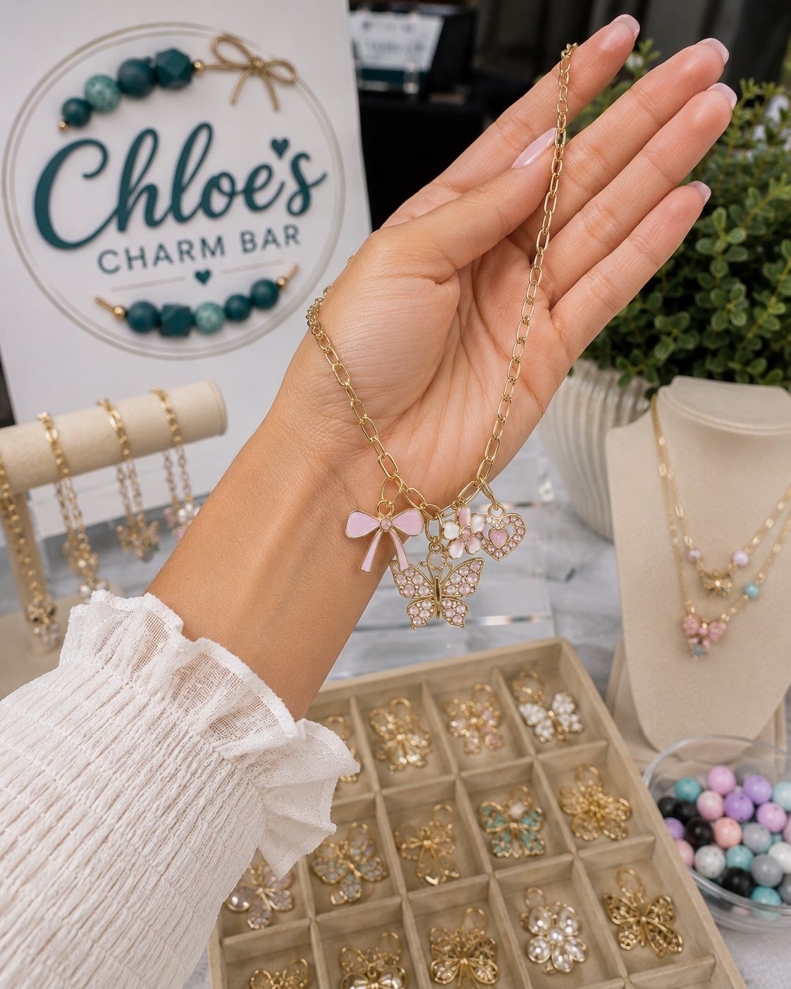 Hand holding a personalized charm necklace